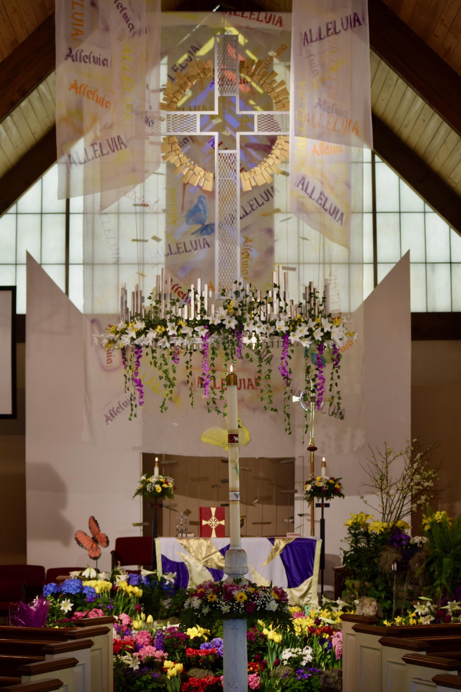 The altar covered in Easter lilies and spring flowers