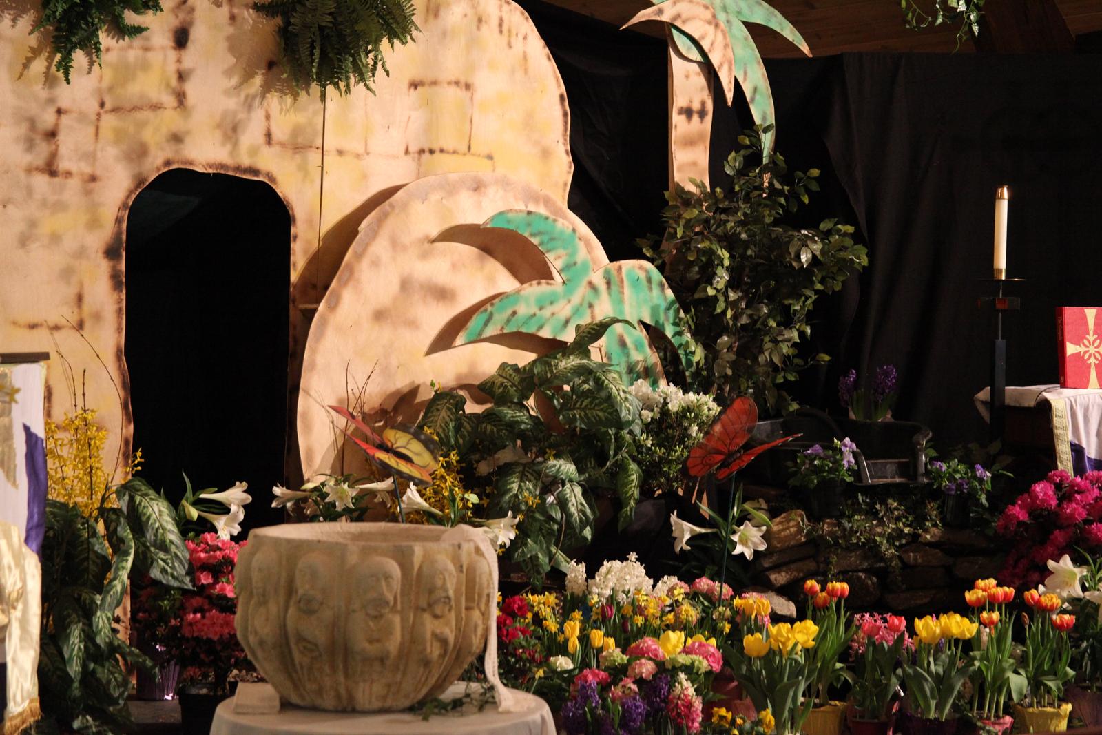 The sanctuary transformed into an Easter Garden, with an empty tomb surrounded by spring flowers