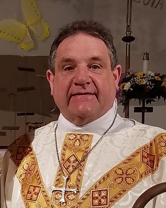 Pastor Timothy Wagner in white and gold vestments